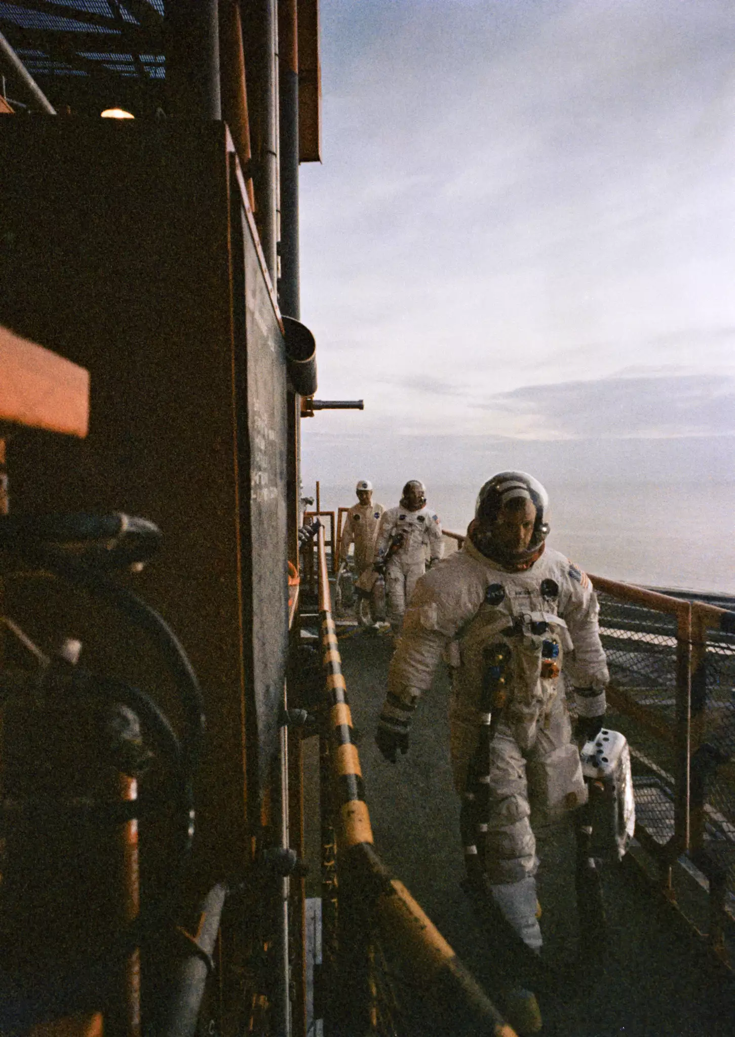 S69-39955 (16 July 1969) --- The crew of the Apollo 11 lunar landing mission arrives atop Pad A, Launch Complex 39, Kennedy Space Center, during the Apollo 11 prelaunch countdown. Leading is astronaut Neil A. Armstrong, commander. He was followed by astronauts Michael Collins, command module pilot. Technician follows directly behind Armstrong and Collins.