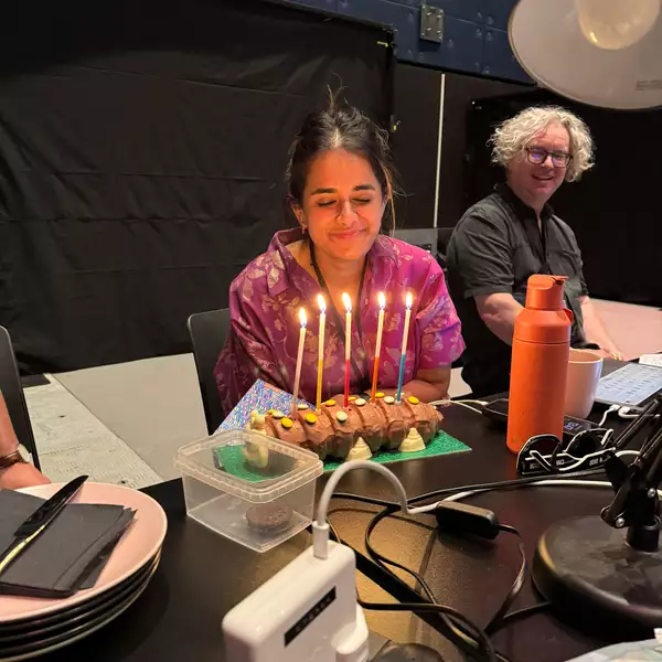 afshan d’souza-lodhi blowing out a caterpillar birthday cake